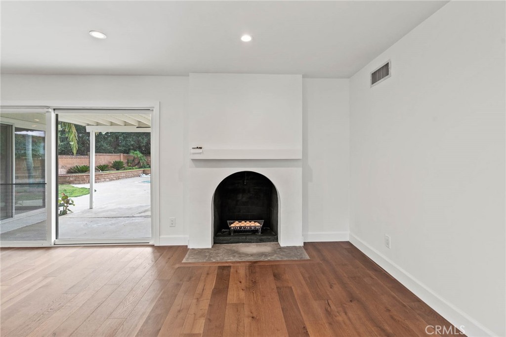 23642 Community Street West Hills, CA 91304 - Photo 9 of 38 a view of a livingroom with wooden floor and a fireplace