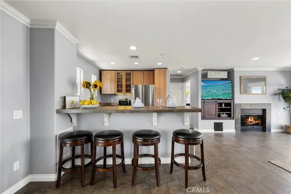 a kitchen with a table chairs refrigerator and cabinets