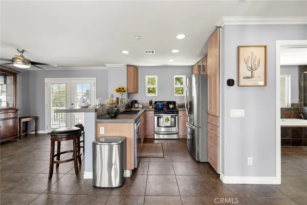 a kitchen with a sink and chairs