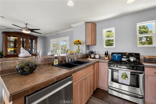 a kitchen with a sink appliances and cabinets