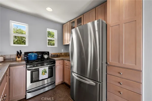 a kitchen with granite countertop stainless steel appliances and refrigerator