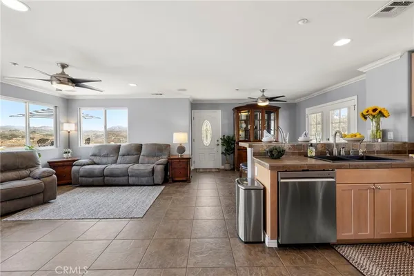 a living room with furniture a counter space and windows