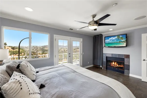 a bedroom with a large bed and a fireplace