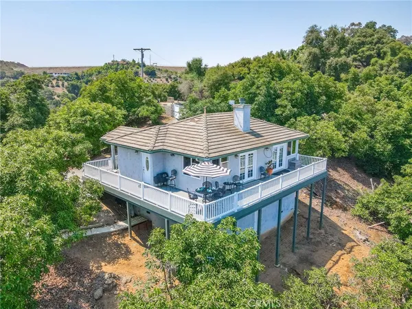 an aerial view of a house having yard and sitting area
