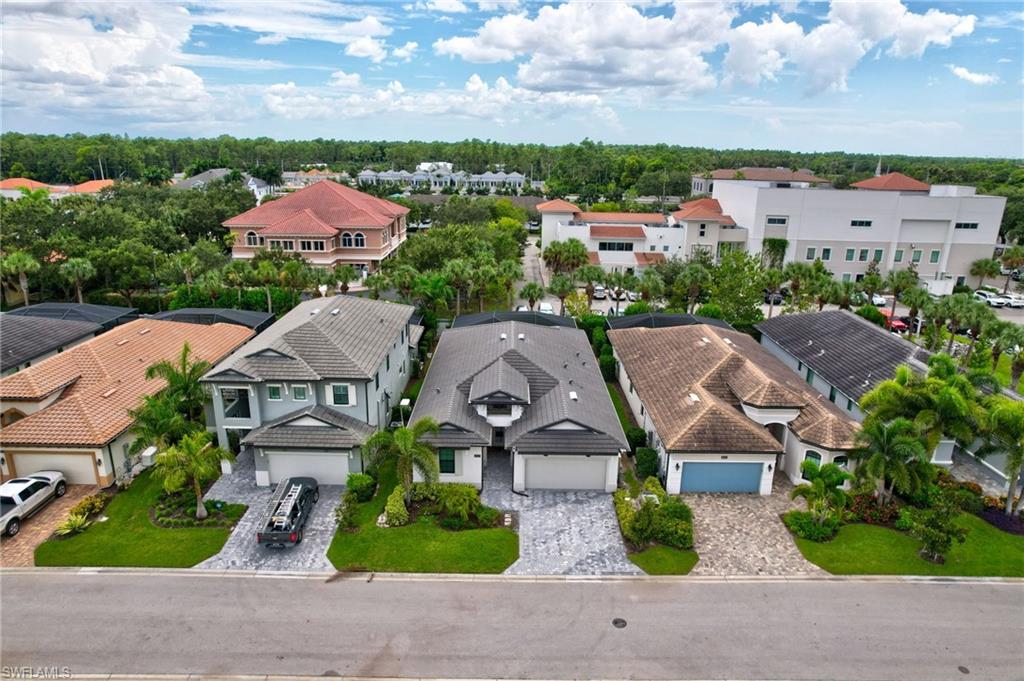 10047 Florence Circle Naples, FL 34119 - Photo 2 of 37 an aerial view of a house with garden space and street view