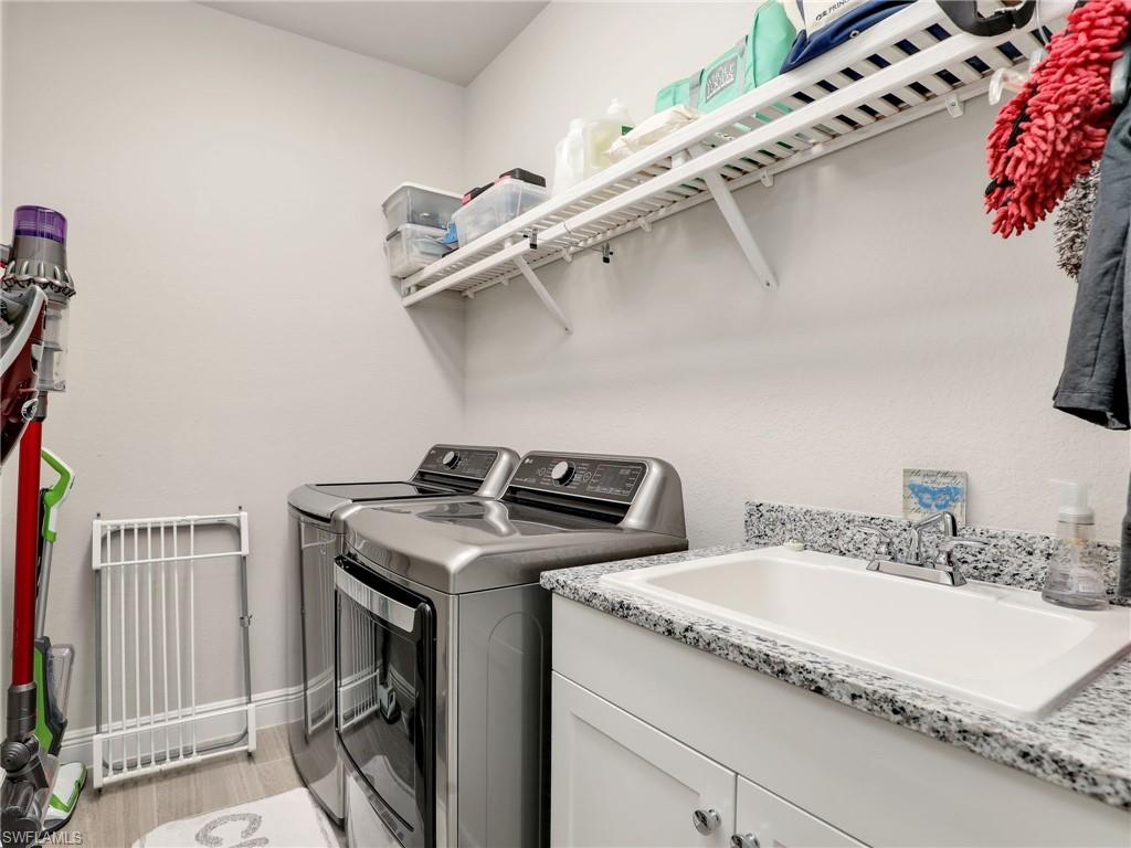 10047 Florence Circle Naples, FL 34119 - Photo 28 of 37 a utility room with dryer and washer