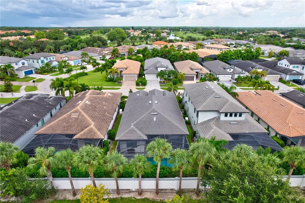 10047 Florence Circle Naples, FL 34119 - Photo 3 of 37 an aerial view of multiple houses with a yard