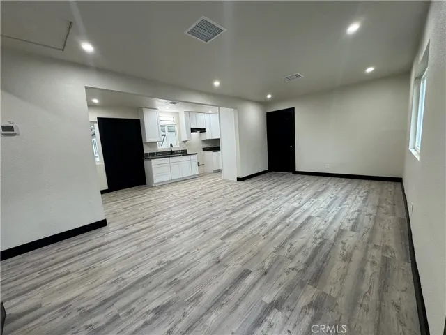 a view of a kitchen with wooden floor