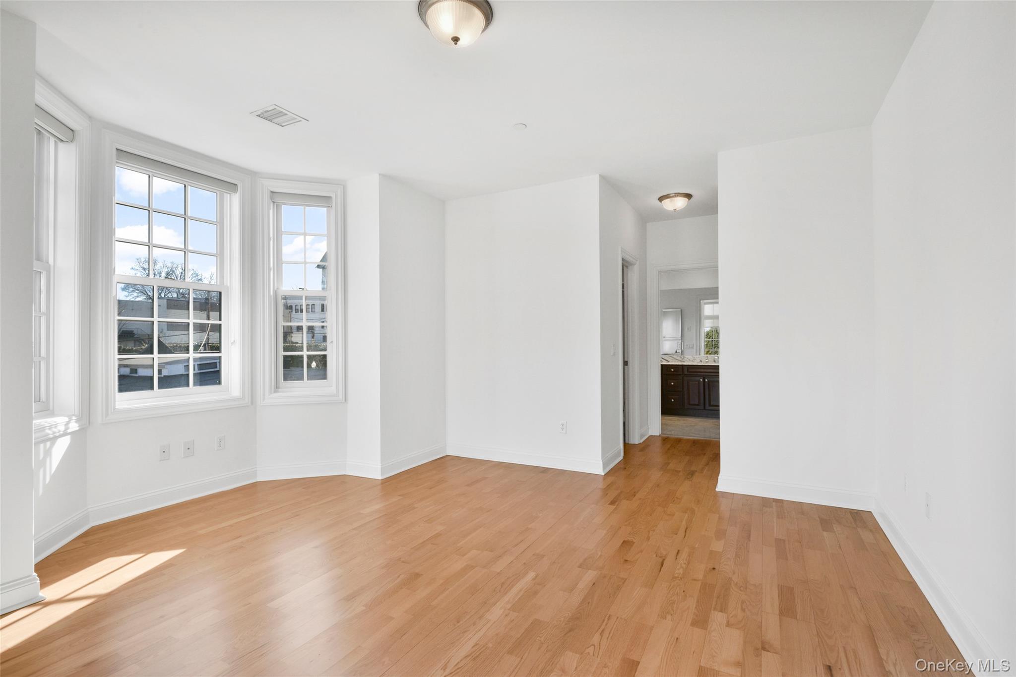 55 1st Street, Unit 207 Pelham, NY 10803 - Photo 12 of 23 Bedroom with light wood-style floors and baseboards
