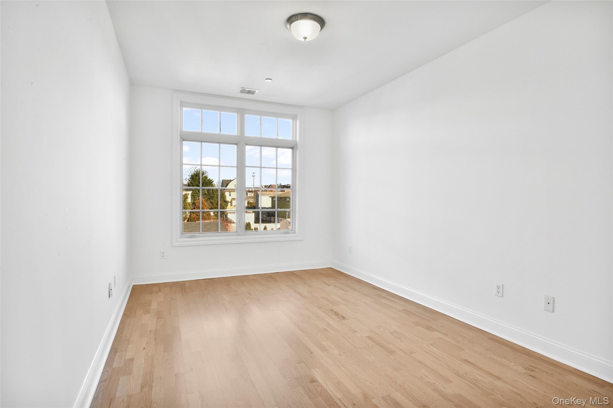 55 1st Street, Unit 207 Pelham, NY 10803 - Photo 10 of 23 Bright bedroom with light wood-type flooring and baseboards