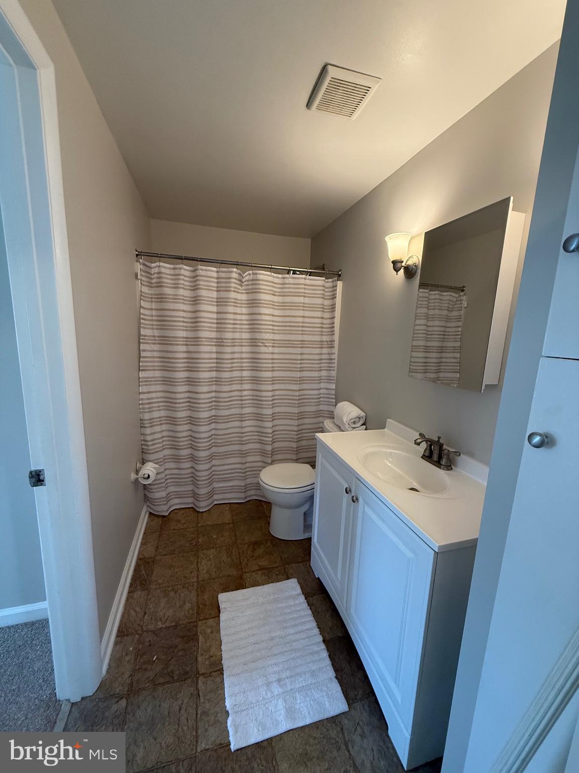 2 Stevens Road Glen Burnie, MD 21060 - Photo 19 of 27 a bathroom with a sink a toilet a mirror and shower