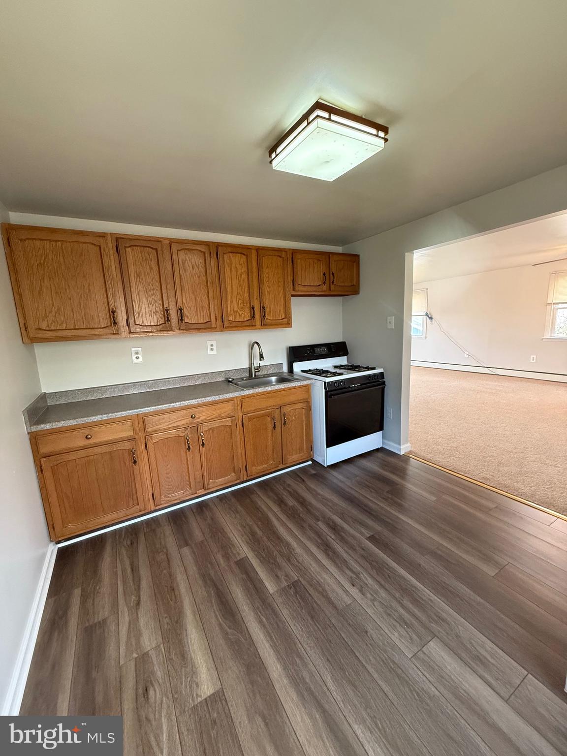2 Stevens Road Glen Burnie, MD 21060 - Photo 22 of 27 a kitchen with wooden floors and refrigerator