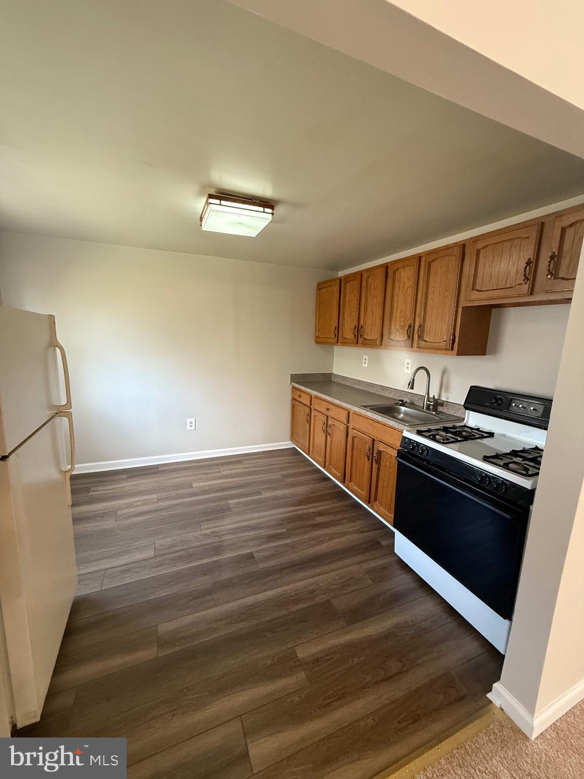2 Stevens Road Glen Burnie, MD 21060 - Photo 23 of 27 a kitchen with stainless steel appliances granite countertop a stove and a refrigerator