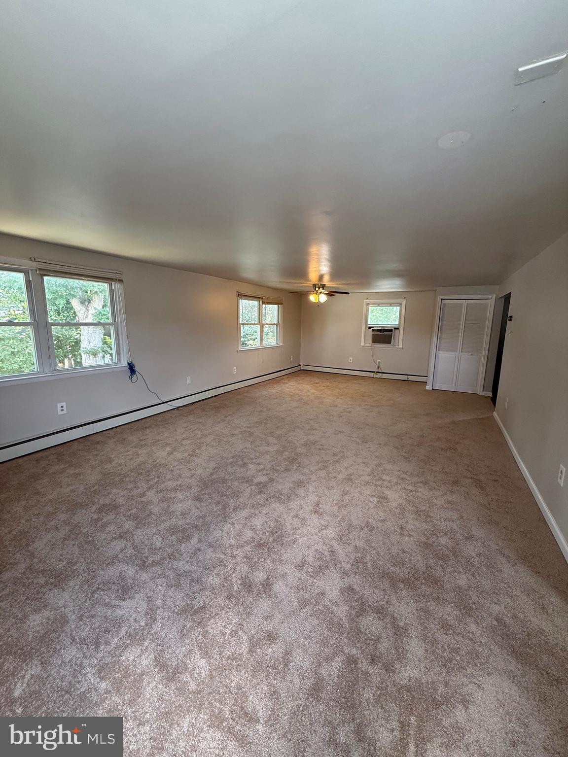 2 Stevens Road Glen Burnie, MD 21060 - Photo 26 of 27 an empty room with windows and way to kitchen