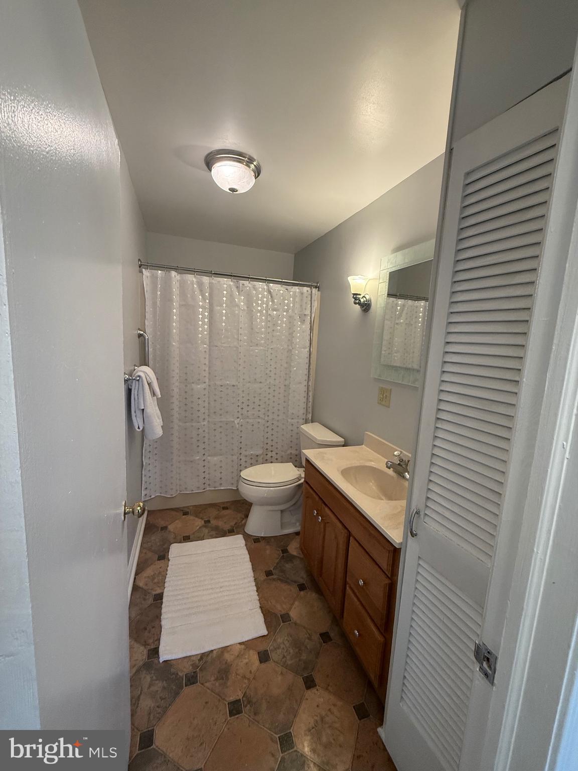 2 Stevens Road Glen Burnie, MD 21060 - Photo 8 of 27 a bathroom with a sink a toilet and shower