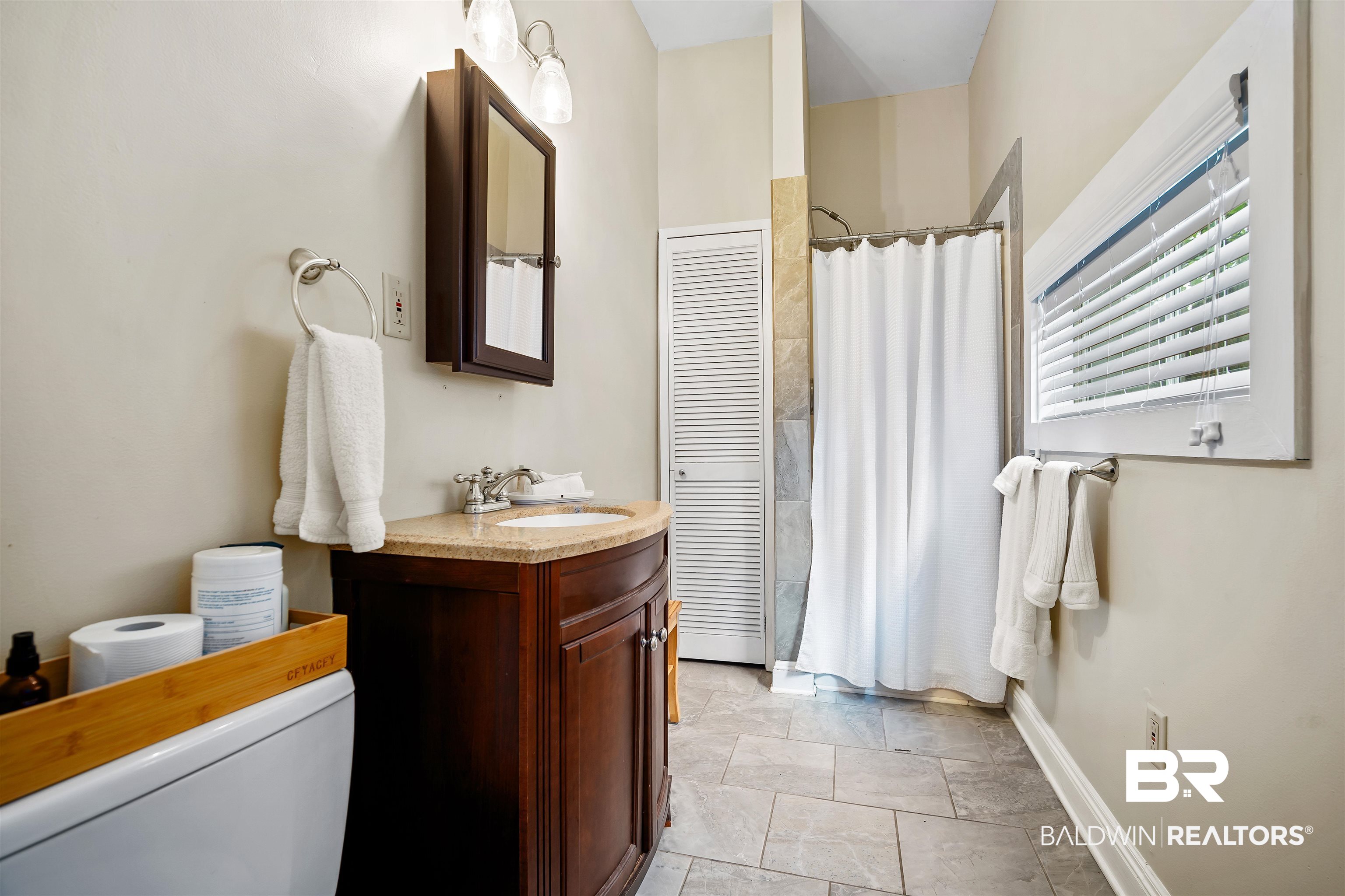 1314 Dauphin Street Mobile, AL 36604 - Photo 54 of 61 Bathroom in guesthouse with a shower with curtain, vanity, and toilet