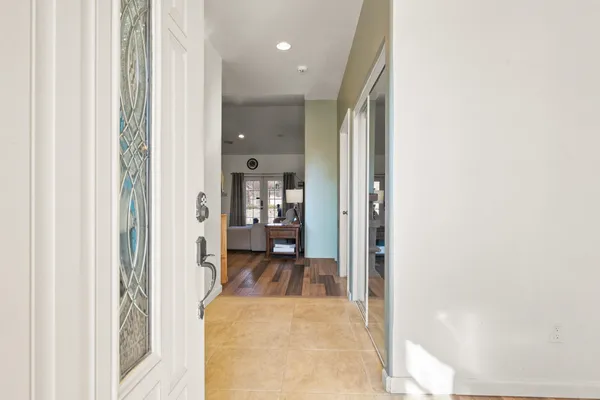 a view of a hallway with a livingroom and a bathroom with sink