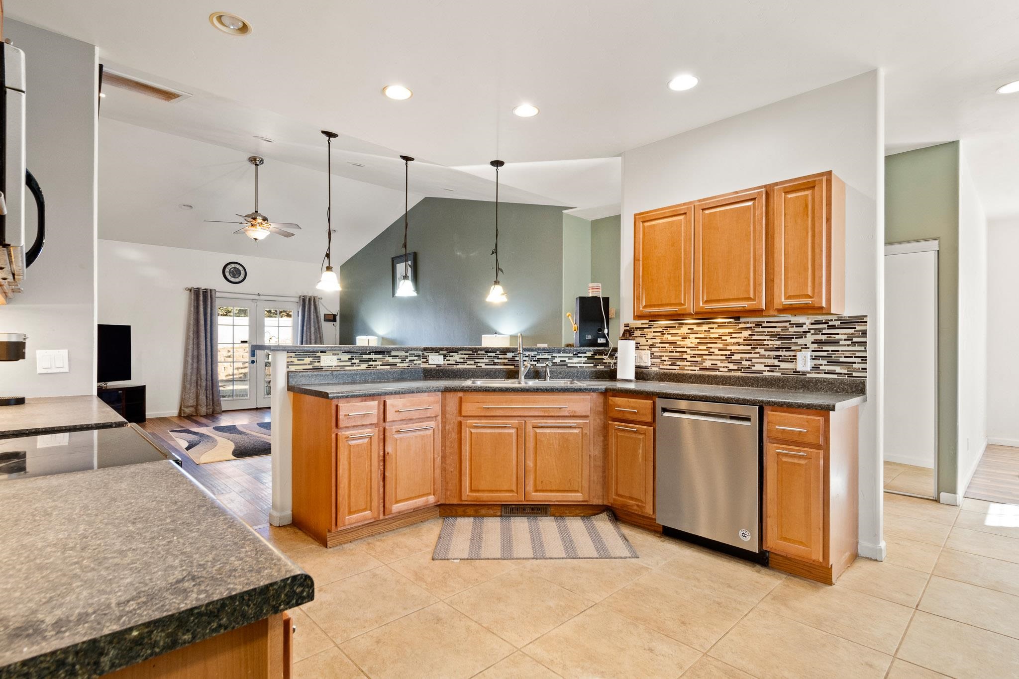 42 Eagle Court Parachute, CO 81635 - Photo 6 of 30 a kitchen with stainless steel appliances granite countertop a stove a sink and a refrigerator