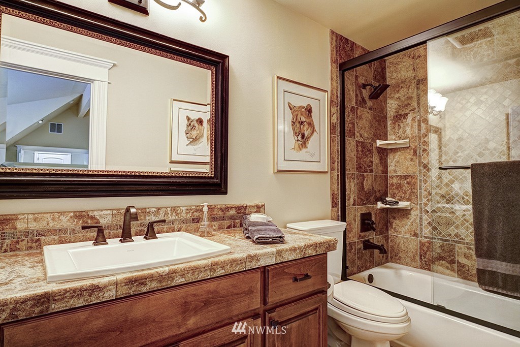25205 Northeast 39th Way Redmond, WA 98053 - Photo 16 of 25 a bathroom with a granite countertop sink toilet and shower