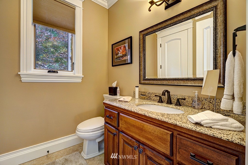25205 Northeast 39th Way Redmond, WA 98053 - Photo 20 of 25 a bathroom with a granite countertop toilet sink and mirror