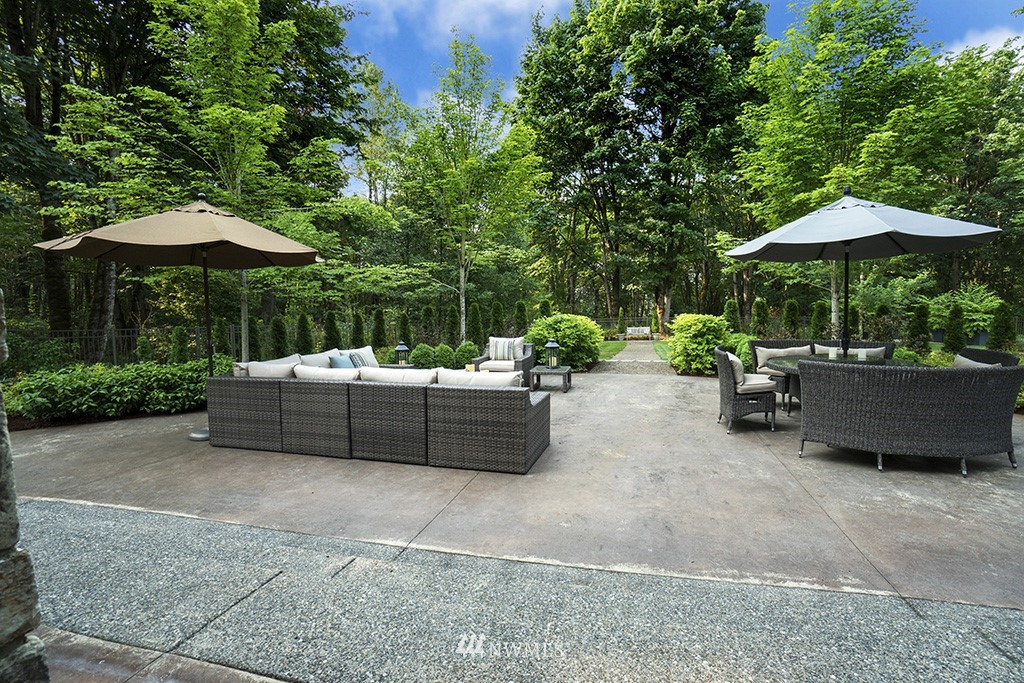25205 Northeast 39th Way Redmond, WA 98053 - Photo 21 of 25 a view of a patio with furniture and table under an umbrella