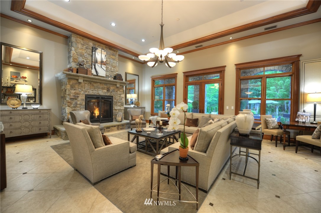 25205 Northeast 39th Way Redmond, WA 98053 - Photo 4 of 25 a living room with furniture a chandelier and a fireplace