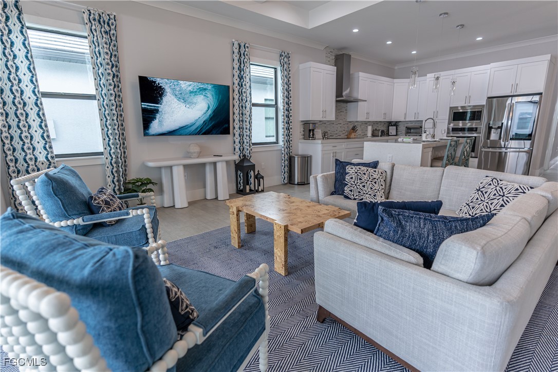795 108th Avenue North Naples, FL 34108 - Photo 13 of 50 a living room with furniture and a flat screen tv