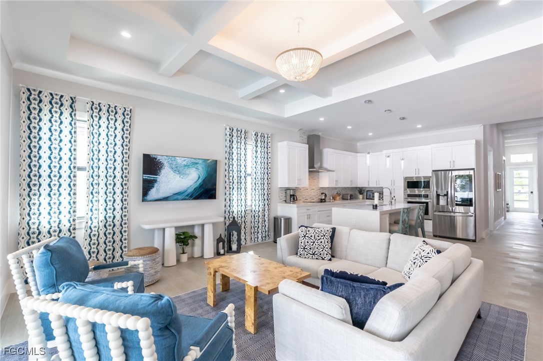 795 108th Avenue North Naples, FL 34108 - Photo 14 of 50 a living room with fireplace furniture and a flat screen tv