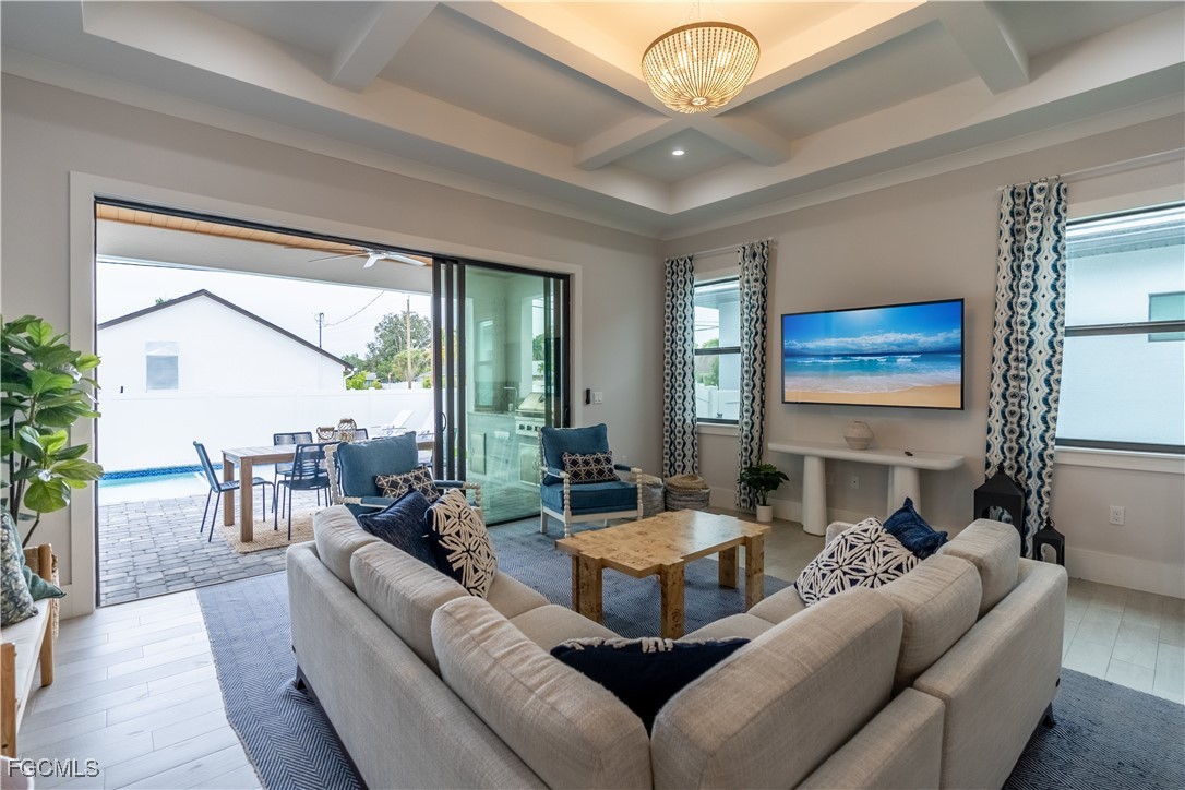 795 108th Avenue North Naples, FL 34108 - Photo 16 of 50 a living room with furniture a large window and a fireplace