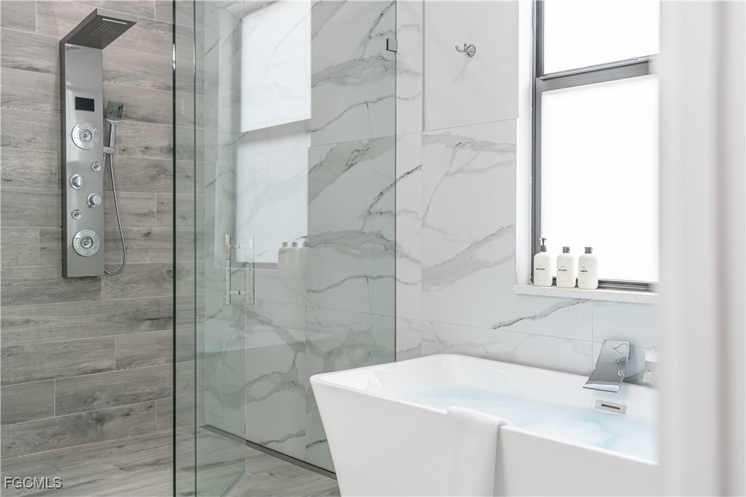 795 108th Avenue North Naples, FL 34108 - Photo 18 of 50 a bathroom with a sink a toilet and shower