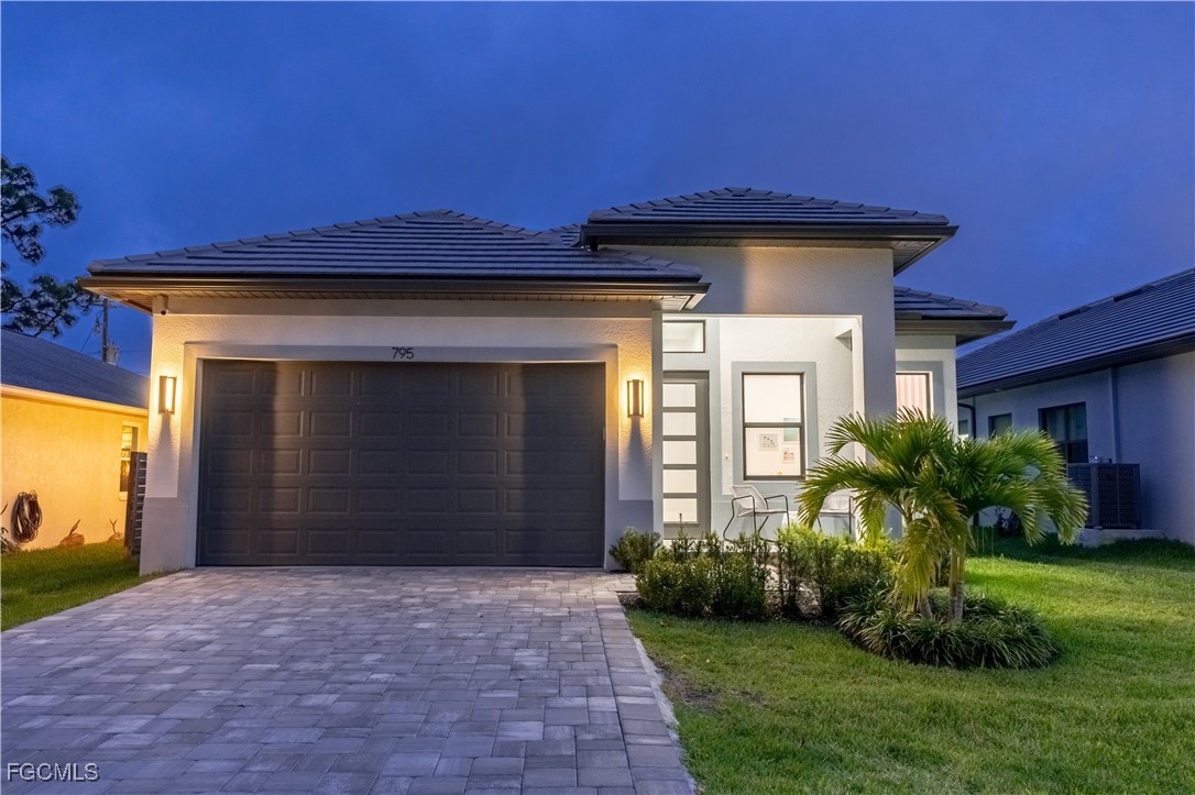 795 108th Avenue North Naples, FL 34108 - Photo 2 of 50 a front view of a house with a yard