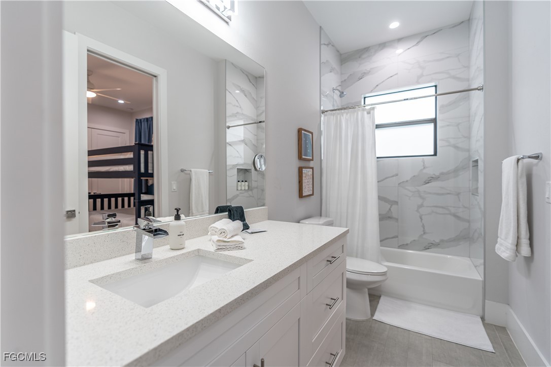 795 108th Avenue North Naples, FL 34108 - Photo 21 of 50 a bathroom with a bathtub shower sink mirror and toilet