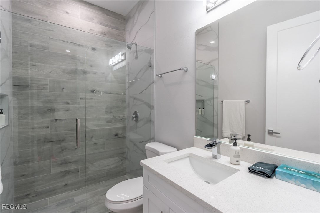 795 108th Avenue North Naples, FL 34108 - Photo 23 of 50 a bathroom with a sink toilet and shower