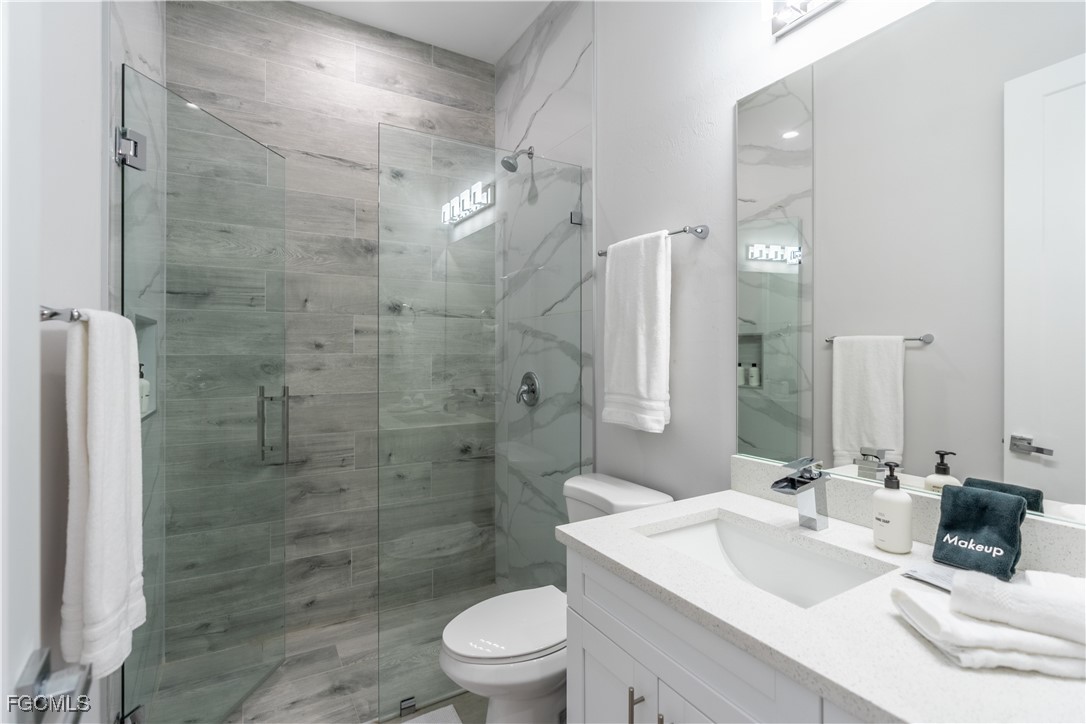 795 108th Avenue North Naples, FL 34108 - Photo 25 of 50 a bathroom with a sink a toilet and shower