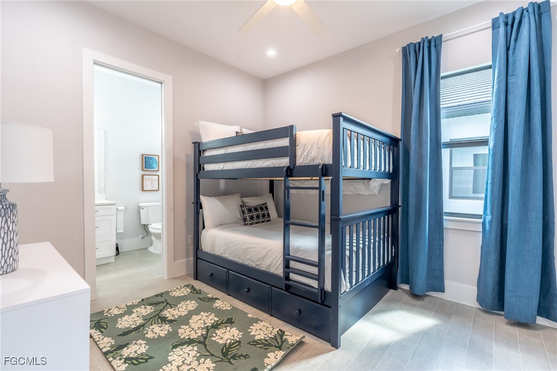 795 108th Avenue North Naples, FL 34108 - Photo 26 of 50 a bedroom with a bed and wooden floor