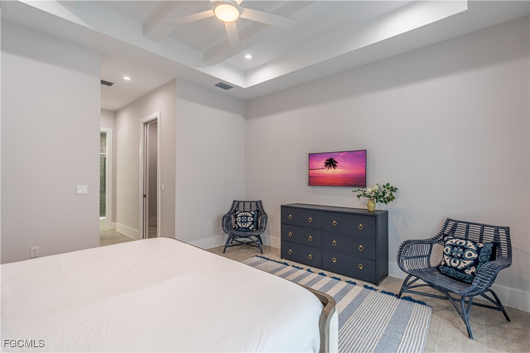 795 108th Avenue North Naples, FL 34108 - Photo 29 of 50 a bedroom with a bed and a dresser in it