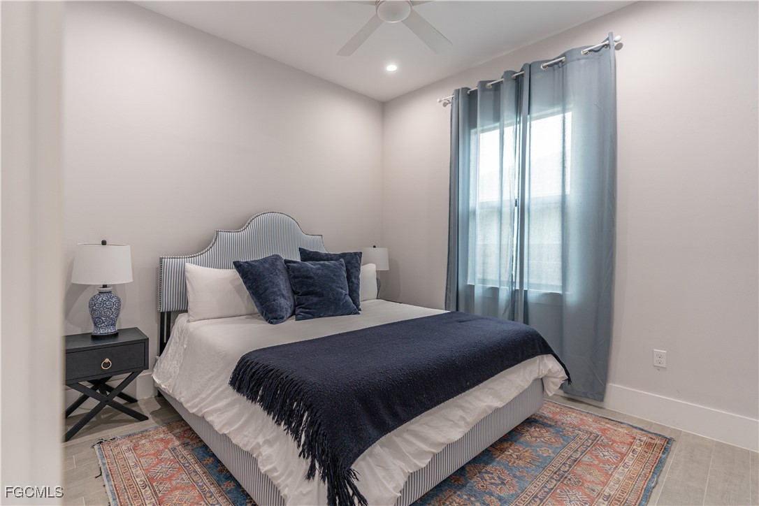 795 108th Avenue North Naples, FL 34108 - Photo 34 of 50 a bedroom with a bed and a mirror