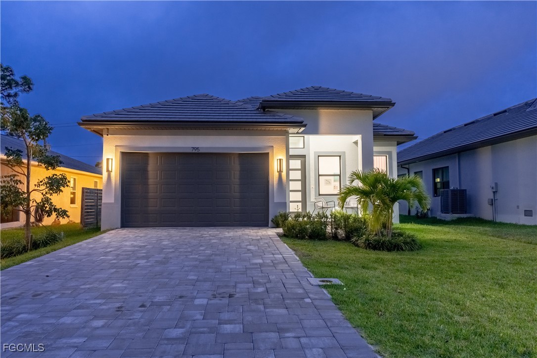 795 108th Avenue North Naples, FL 34108 - Photo 44 of 50 a front view of a house with a yard and garage