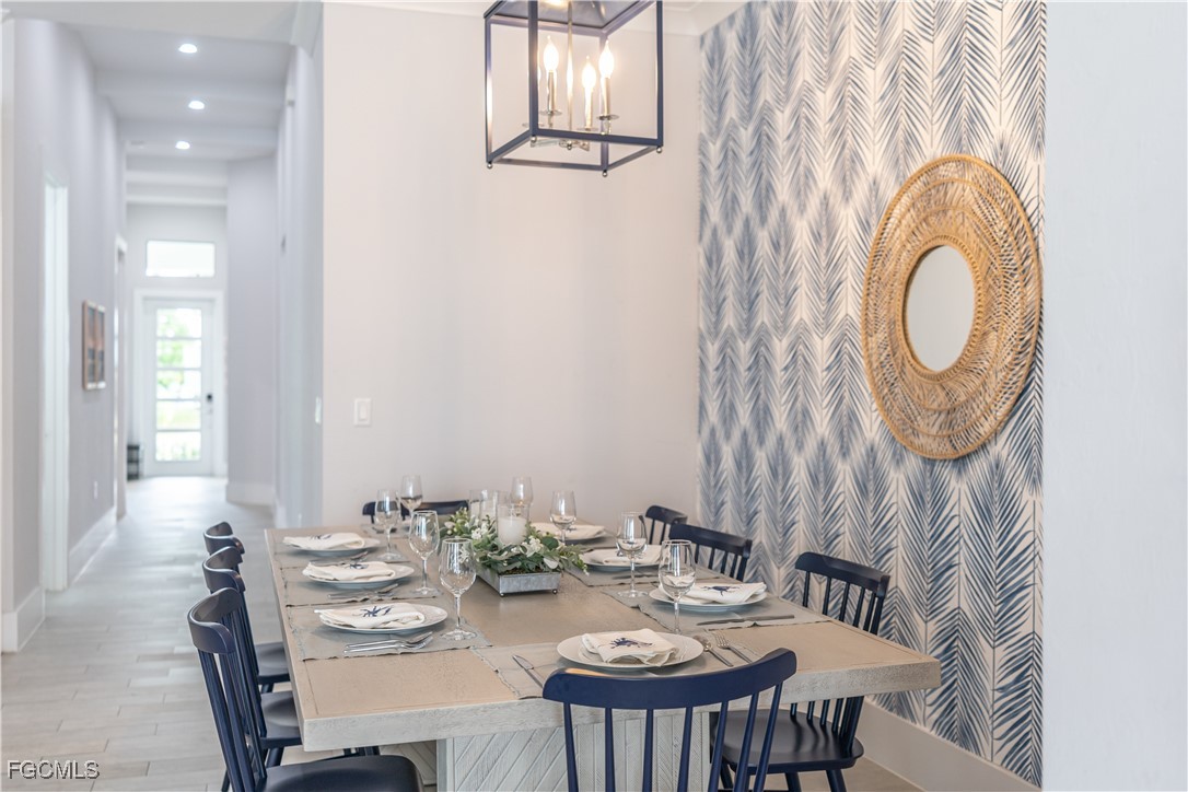 795 108th Avenue North Naples, FL 34108 - Photo 5 of 50 a view of a dining room with furniture and chandelier
