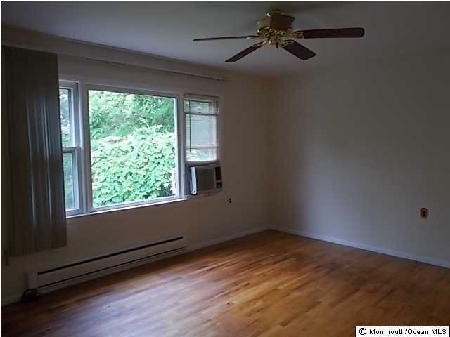 1761 Forge Pond Road Brick, NJ 08724 - Photo 5 of 12 en empty room with wooden floor and windows