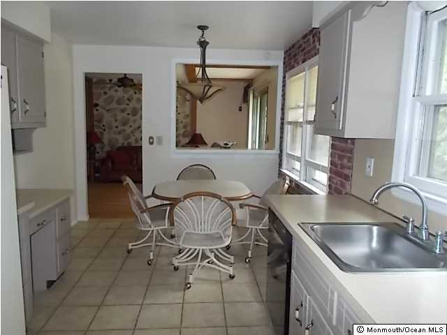 1761 Forge Pond Road Brick, NJ 08724 - Photo 6 of 12 a kitchen with a sink cabinets and window