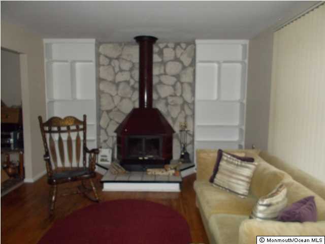 1761 Forge Pond Road Brick, NJ 08724 - Photo 7 of 12 a living room with furniture and a fireplace