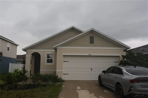 a front view of a house with parking space