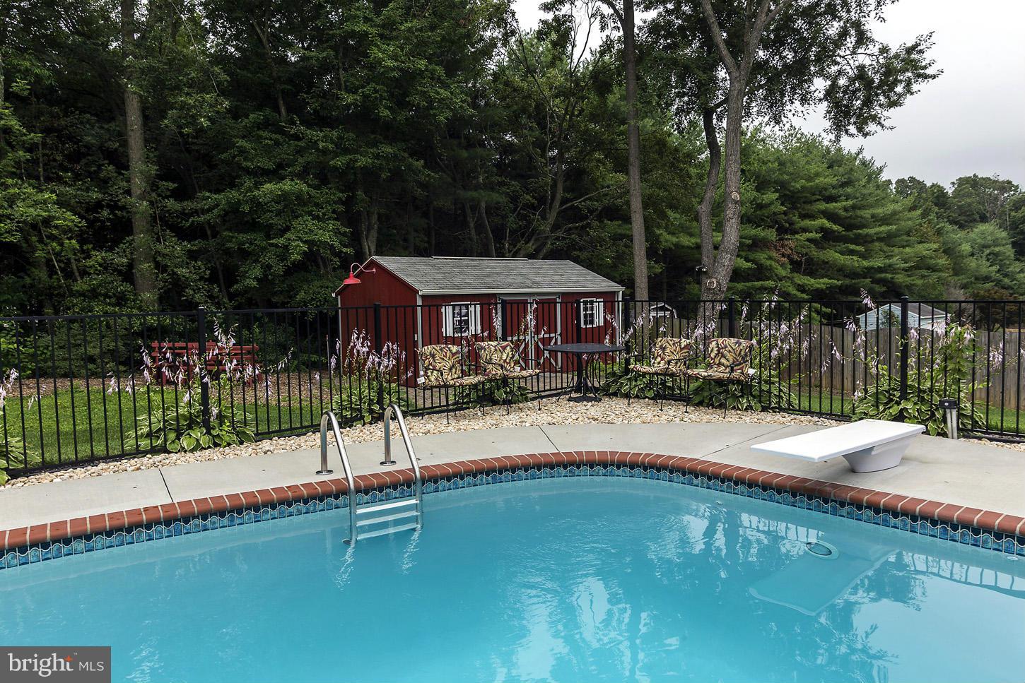 3701 Altondale Road Reisterstown, MD 21136 - Photo 27 of 29 a swimming pool view with a seating space and a forest view