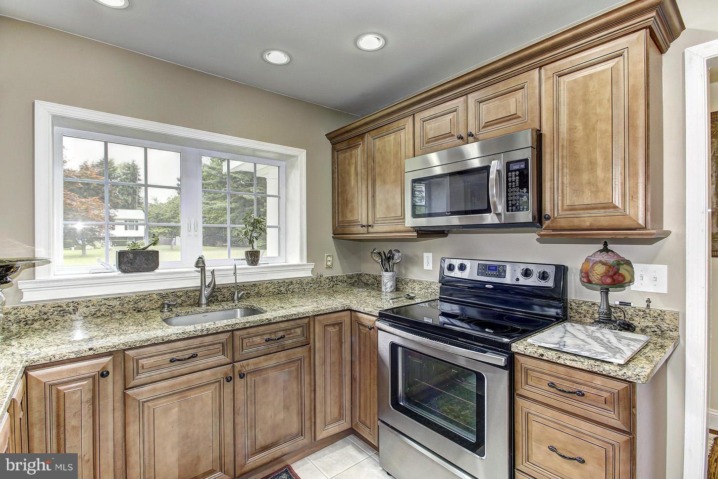 3701 Altondale Road Reisterstown, MD 21136 - Photo 4 of 29 a kitchen with granite countertop a stove sink and microwave