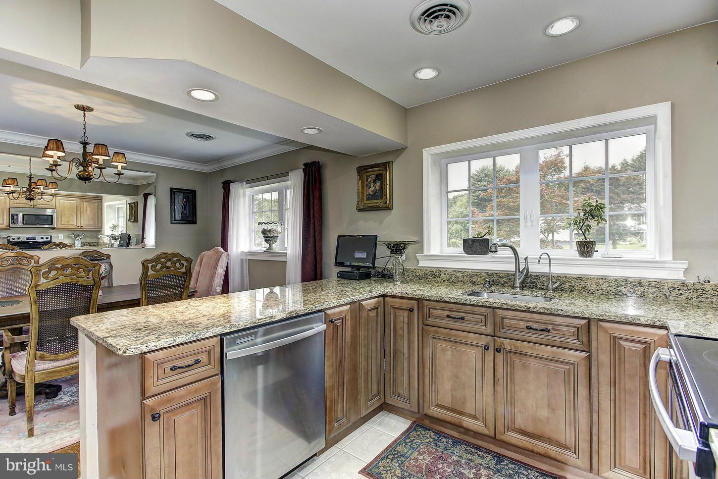 3701 Altondale Road Reisterstown, MD 21136 - Photo 5 of 29 a kitchen with stainless steel appliances granite countertop a sink stove and cabinets