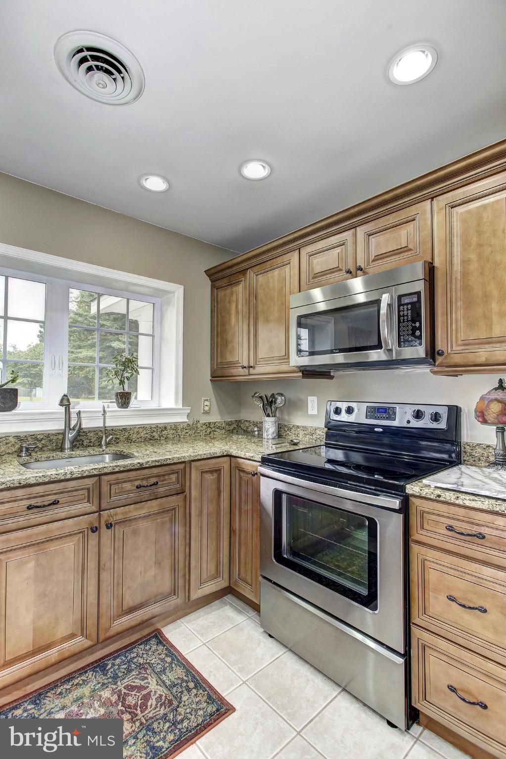 3701 Altondale Road Reisterstown, MD 21136 - Photo 6 of 29 a kitchen with stainless steel appliances granite countertop a stove and a microwave