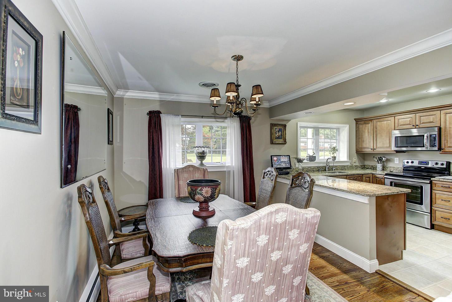 3701 Altondale Road Reisterstown, MD 21136 - Photo 8 of 29 a dining room with kitchen island stainless steel appliances furniture a chandelier and kitchen view