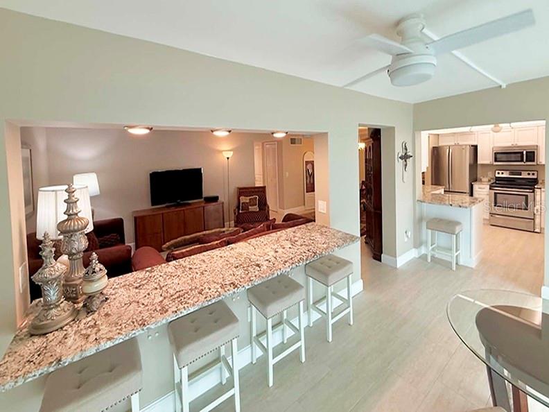 4455 Duhme Road, Unit 103 St. Petersburg, FL 33708 - Photo 6 of 37 a living room with furniture and a flat screen tv