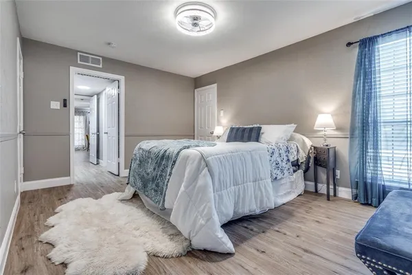 a bedroom with a bed and a mirror